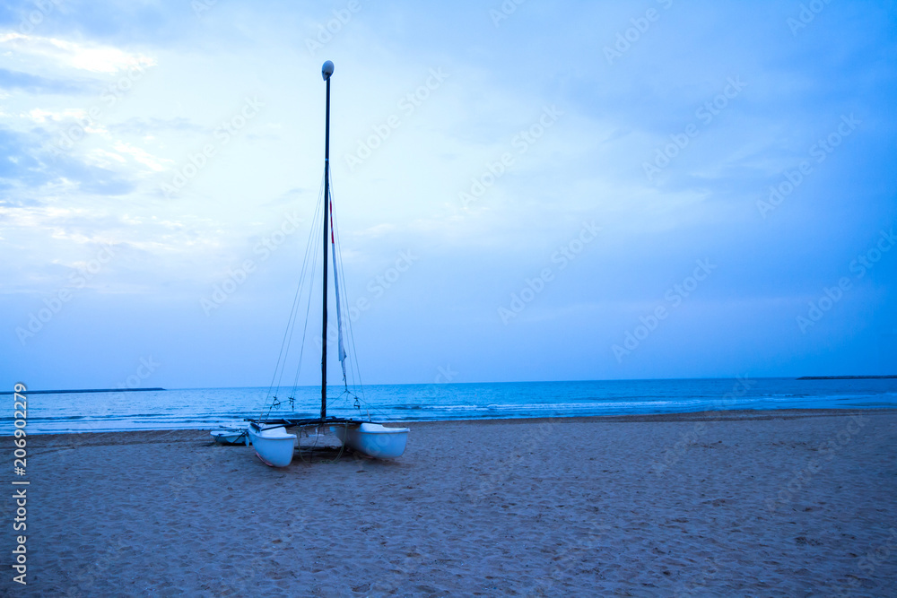 Row and sail boat on al hamra beach at Ras Al Khaima, UAE