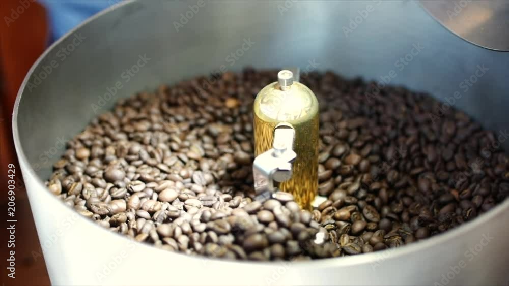 Mixing of roasted coffee. Partial removal of bad grains. The roasted coffee beans got on the mixer sorting by a professional machine. Slow motion. Mixing of roasted coffee. Partial removal of bad grains. The roasted coffee beans got on the mixer sorting by a professional machine. Slow motion.