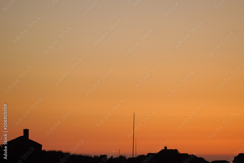 orange sunset, silhouette of the henne beach