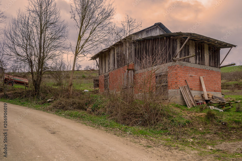 Old abandoned barn in a large field with cloudy sky at Mudurnu mountains, Turkey Old abandoned barn in a large field with cloudy sky at Mudurnu mountains, Turkey
