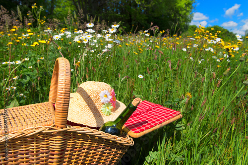 Picnic basket in summer flower field