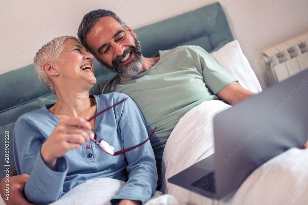 Mature couple using laptop together Mature couple using laptop together