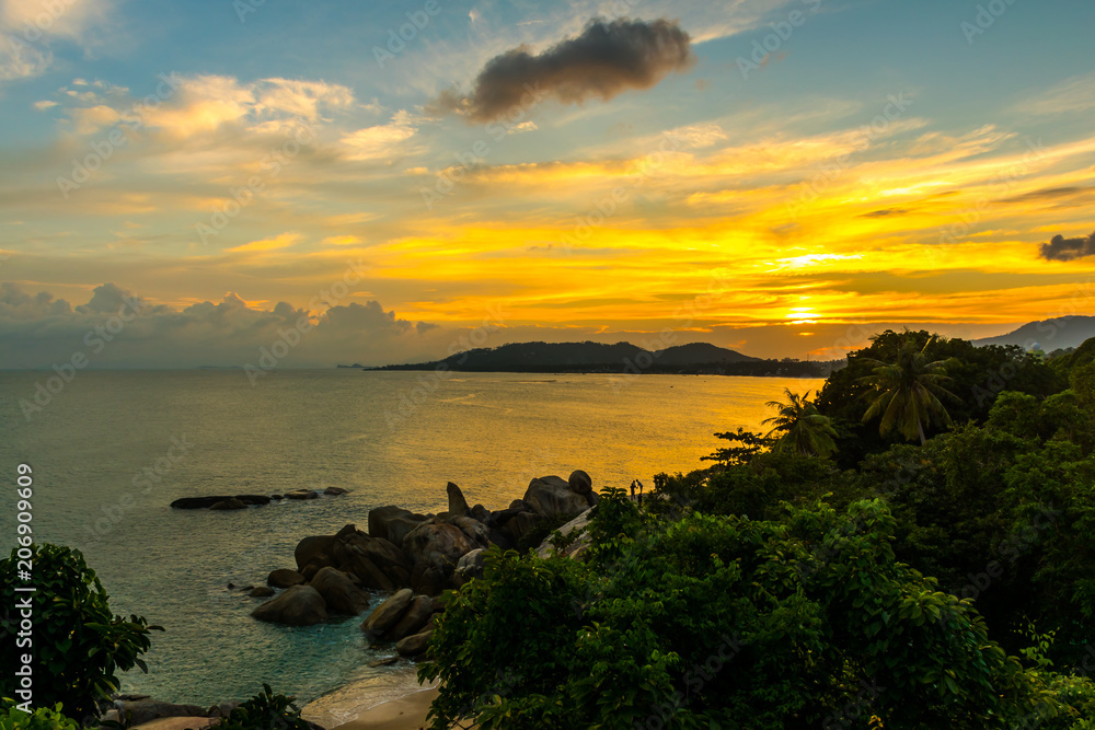 The Rock Hin Ta and Hin Yai from Thailand Island of Koh Samui. The picturesque pile of rocks on the beach, illuminated by the sunset.