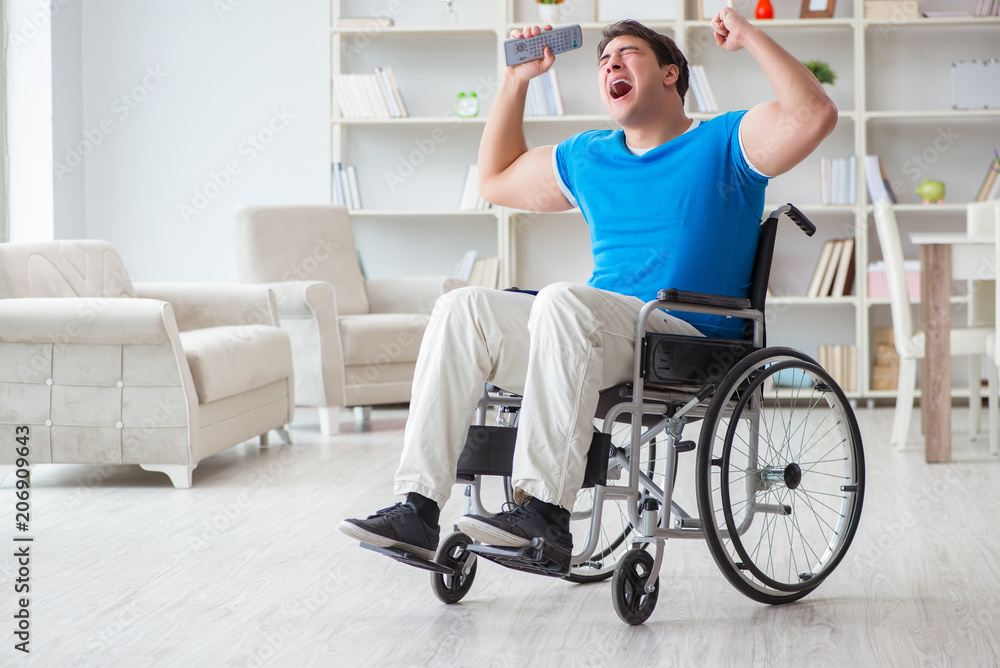 Disabled man watching sports on tv Disabled man watching sports on tv
