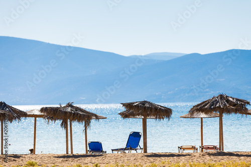 Sun parasols and deck chairs on beach