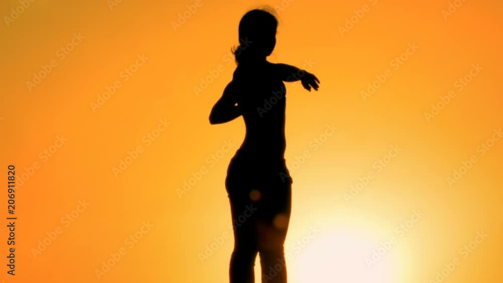 Athletic female stretching before doing yoga sunset, health care, inner harmony Athletic female stretching before doing yoga sunset, health care, inner harmony