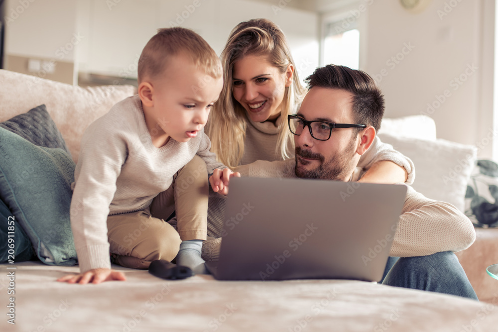 Family using laptop together Family using laptop together