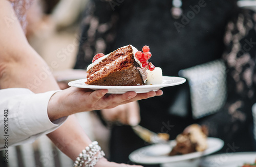 hand holding plates of cake