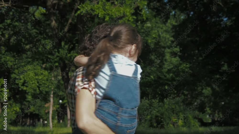 Happy family in nature. The daughter hugs Mom. Happy family in nature. The daughter hugs Mom.