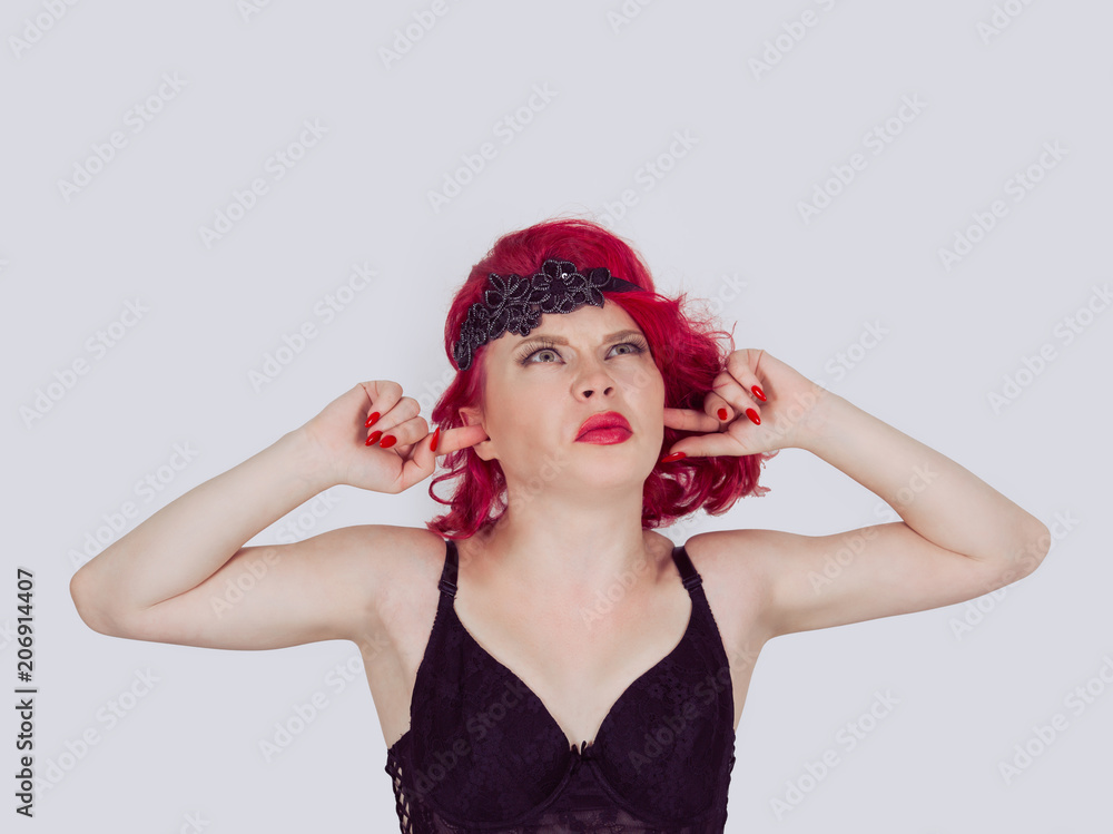 woman girl plugging the ears looking up upwards woman girl plugging the ears looking up upwards