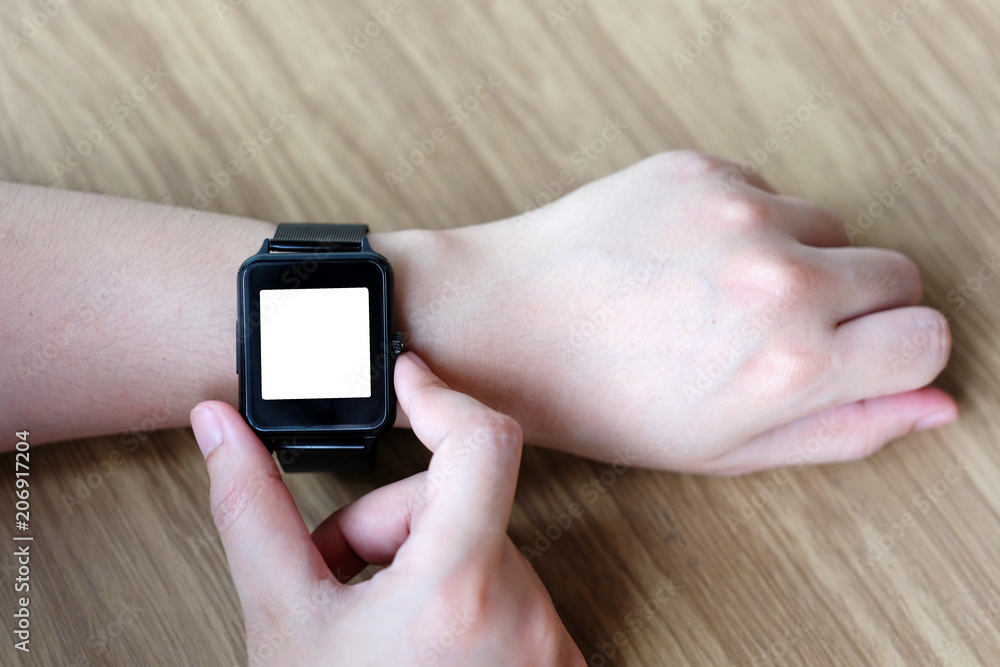 Man hand touching smartwatch with blank on screen, mock up, template, technology lifestyle concept Man hand touching smartwatch with blank on screen, mock up, template, technology lifestyle concept