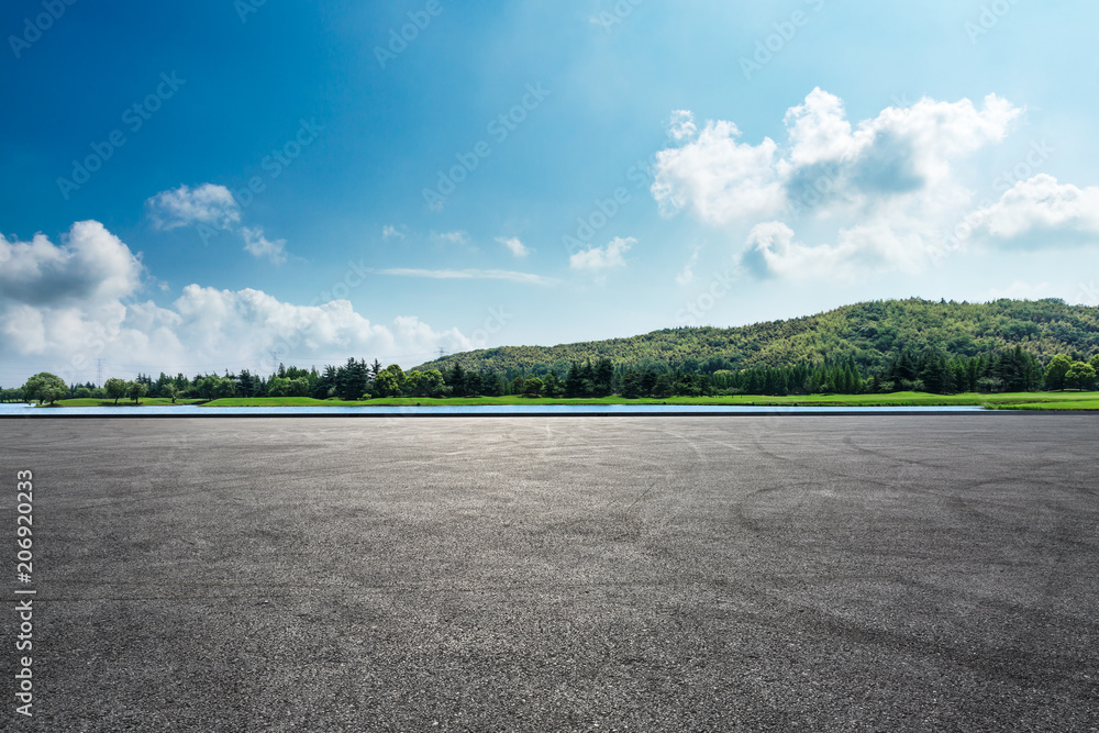 Asphalt square road and hills with sky clouds landscape - obrazy, fototapety, plakaty 