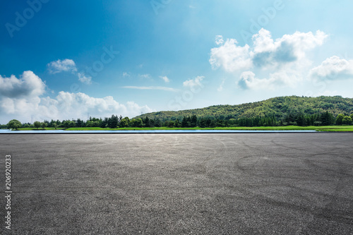 Asphalt square road and hills with sky clouds landscape photo