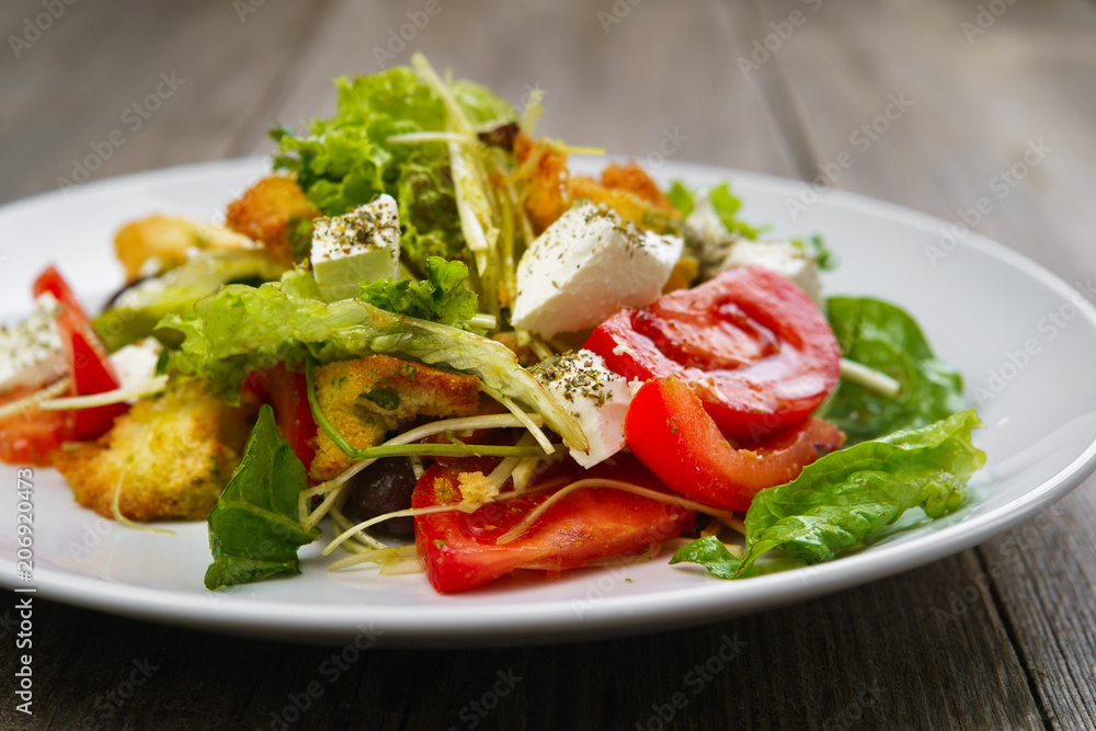 Appetizing vegetable salad with letuce and croutons. Mediterranean cuisine, banquet, restaurant menu food photo, dining concept