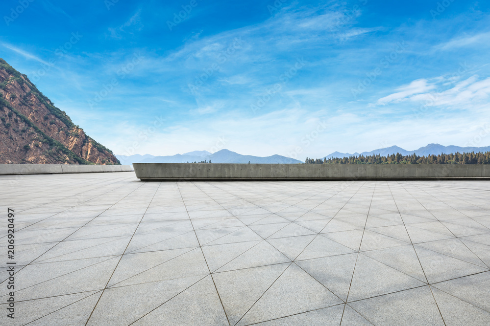 Empty square floor and hills with sky clouds Empty square floor and hills with sky clouds