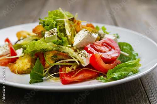 Appetizing vegetable salad with letuce and croutons. Mediterranean cuisine, banquet, restaurant menu food photo, dining concept