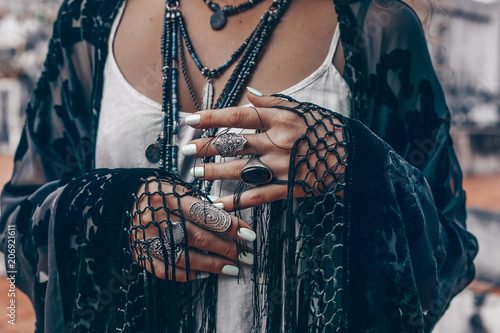 stylish woman hands close up with boho accessories