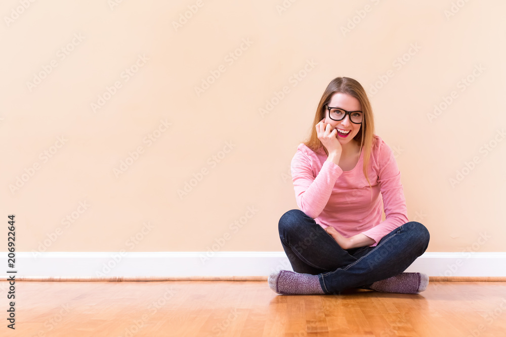 Young woman thinking about something in a big room