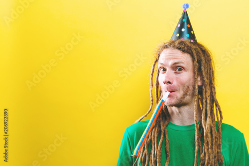 Young man with party theme on a yellow background