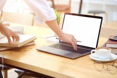 Cropped shot of an attractive young businesswoman working Witt laptop at her office desk