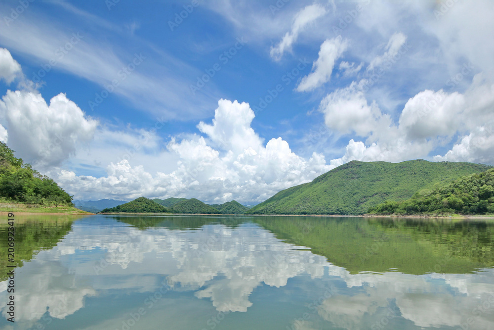 Fototapeta premium The Islands and mountains on reservior in dam. On the day of clouds and cloud reflection in the beautiful water of KaengKrachan National Park.