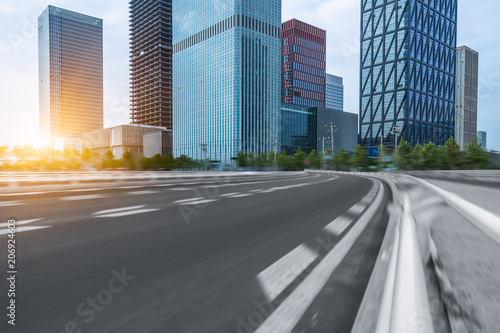 city empty traffic road with cityscape in background.