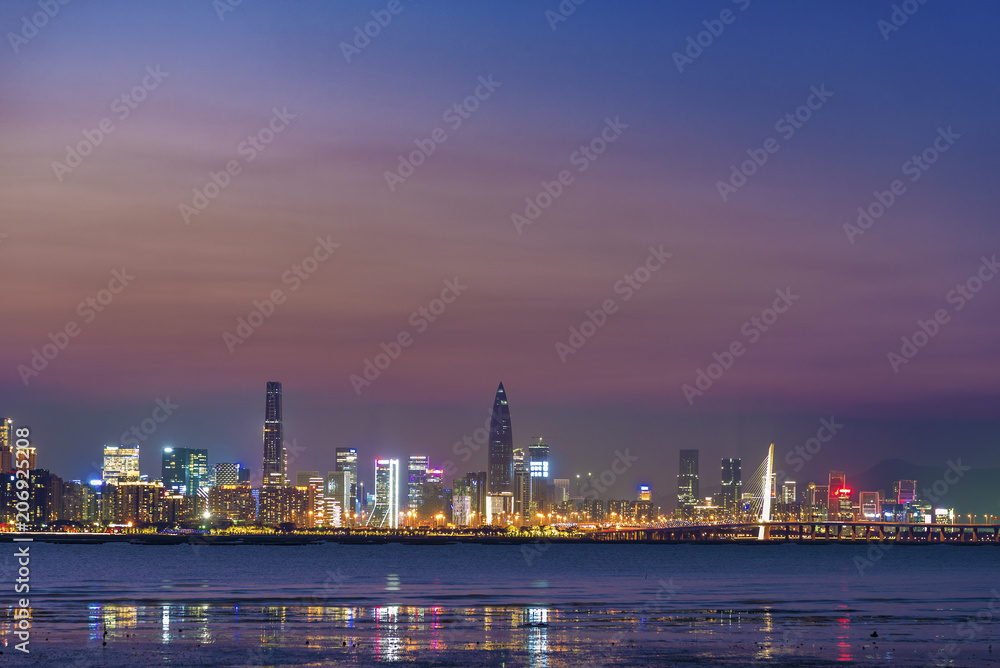 Skyline of Shekou district, Shenzhen city, China at dusk. Viewed from Hong Kong