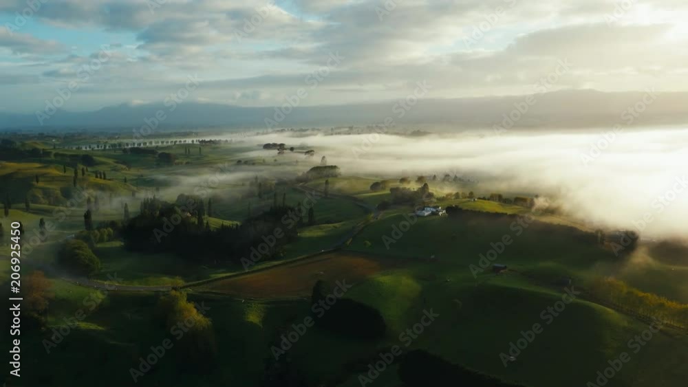 Drone shot panoramic countryside at sunset with heavy low hanging clouds Drone shot panoramic countryside at sunset with heavy low hanging clouds