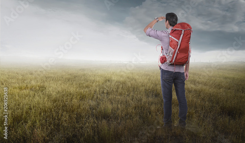 Attractive asian traveler man with backpack looking at landscapes