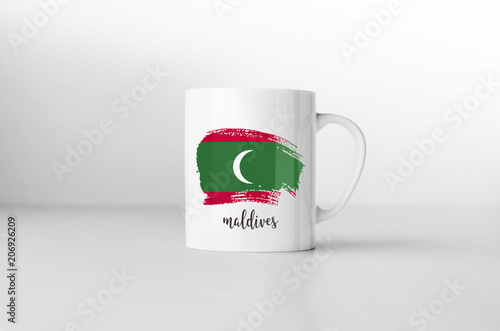 Maldives flag souvenir mug on white background. 3D rendering.