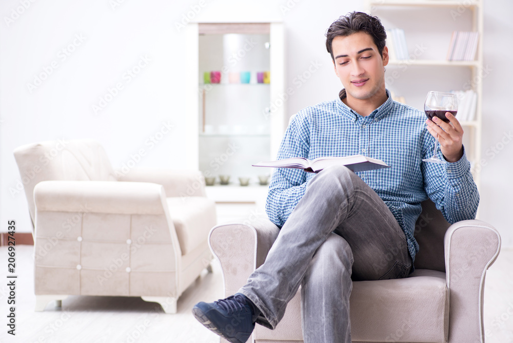 Young man drinking wine at home Young man drinking wine at home