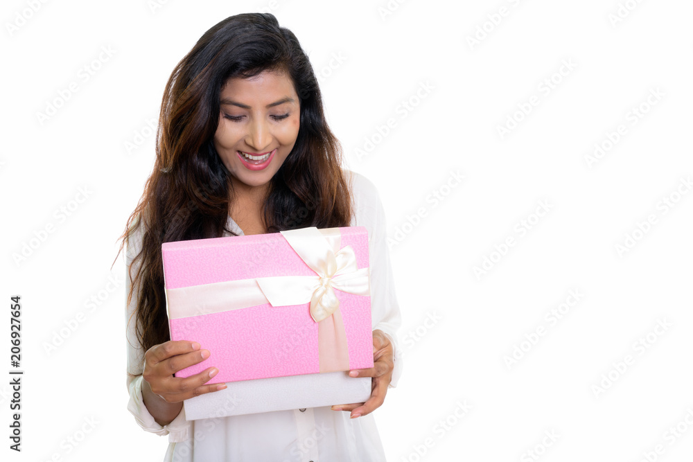 Studio shot of young happy Persian woman smiling while opening g Studio shot of young happy Persian woman smiling while opening g