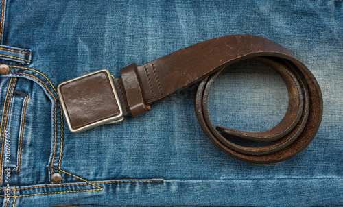 a rolled-up belt on blue jeans.