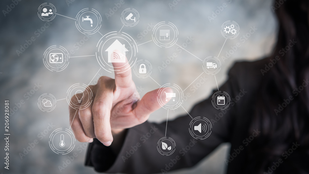 Circular futuristic interface of smart home automation assistant on a virtual screen and a user touching a home button Circular futuristic interface of smart home automation assistant on a virtual screen and a user touching a home button