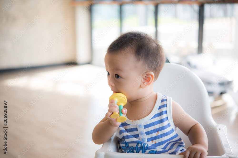Asian cute baby boy are eating fruit from the accessory. Asian cute baby boy are eating fruit from the accessory.