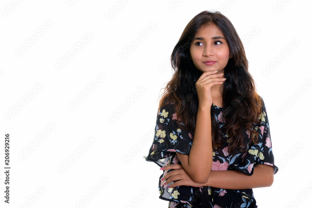 Studio shot of young beautiful Persian woman thinking while look Studio shot of young beautiful Persian woman thinking while look
