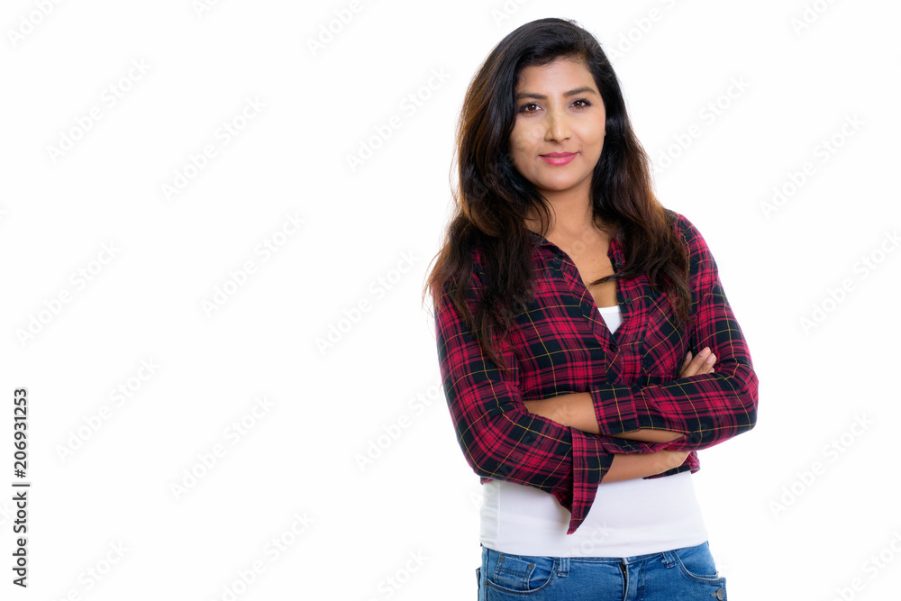 Studio shot of young beautiful Persian woman with arms crossed i Studio shot of young beautiful Persian woman with arms crossed i