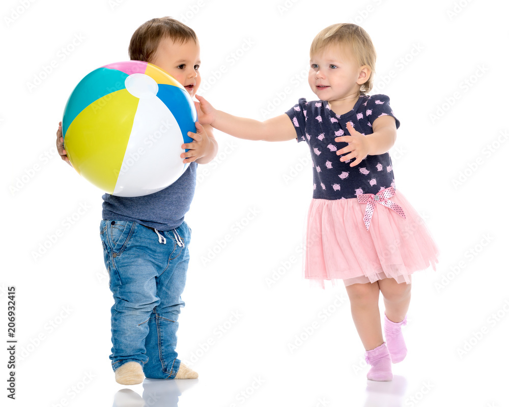 Toddler boy and girl playing with ball. Toddler boy and girl playing with ball.