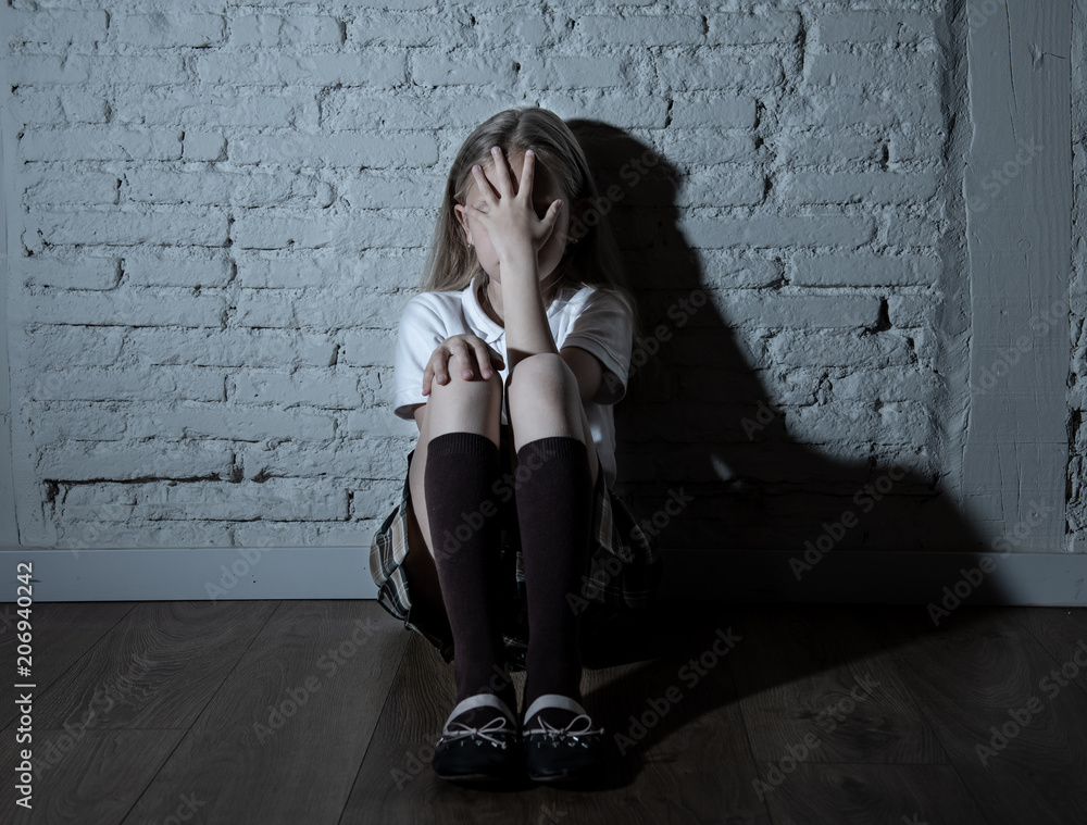 Fotografie Depressed child victim of bullying feeling sad, unhappy, lonely, scared and isolated