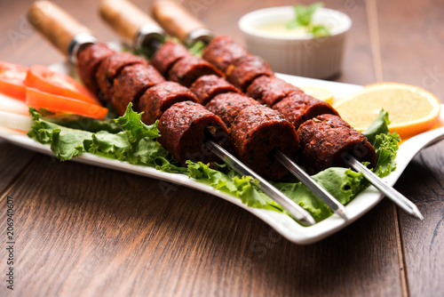Indian Mutton Seekh Kabab served with green salad, selective focus