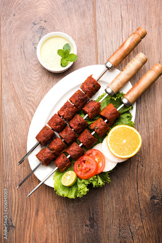 Indian Mutton Seekh Kabab served with green salad, selective focus photo