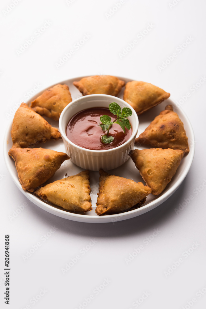 homemade mini samosa served with red sauce, selective focus homemade mini samosa served with red sauce, selective focus