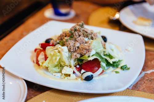 Italian tuna salad including cabbage, tomato, olive and tuna.