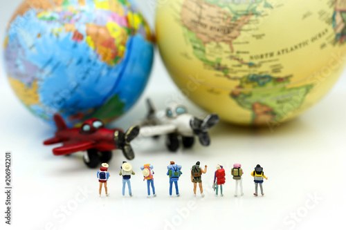 Miniature people : Travelers with world globe and airplane , traveling or exploring the world, budget travel concepts.