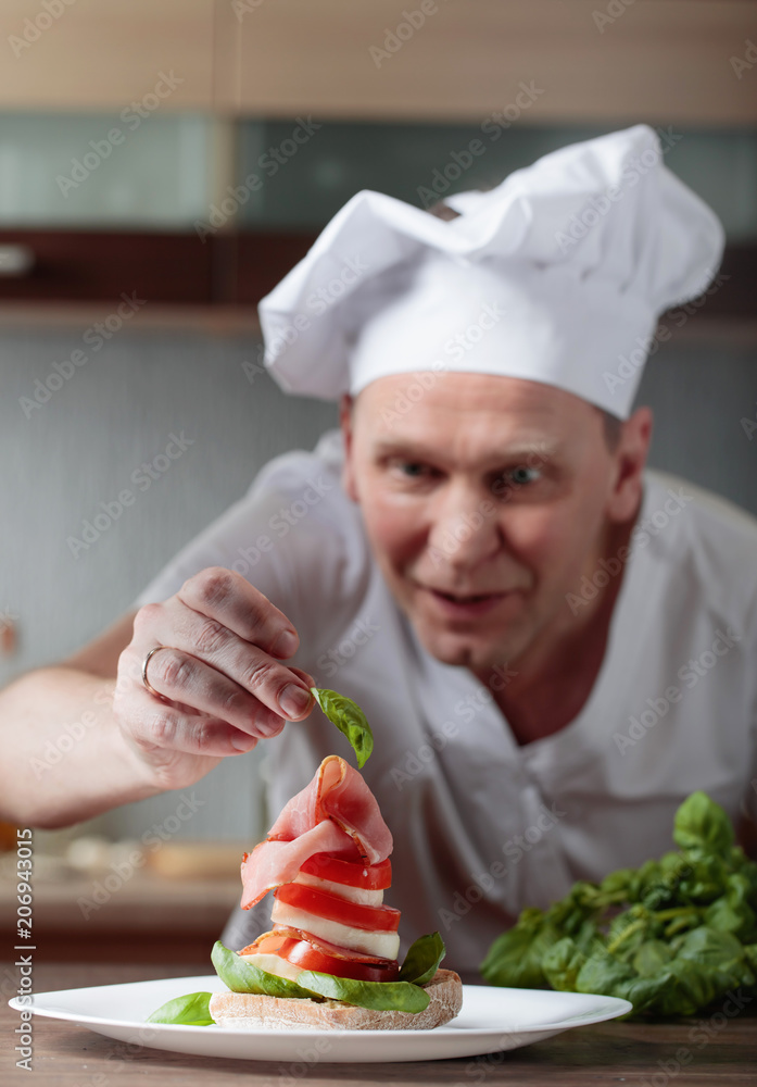Chef prepares a snack with mozzarella and smoked meat . Chef prepares a snack with mozzarella and smoked meat .