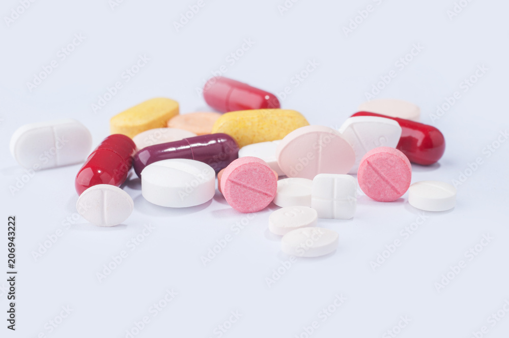 Medical pills and supplement capsules with different size, shape and color isolated over white background. Medical pills and supplement capsules with different size, shape and color isolated over white background.