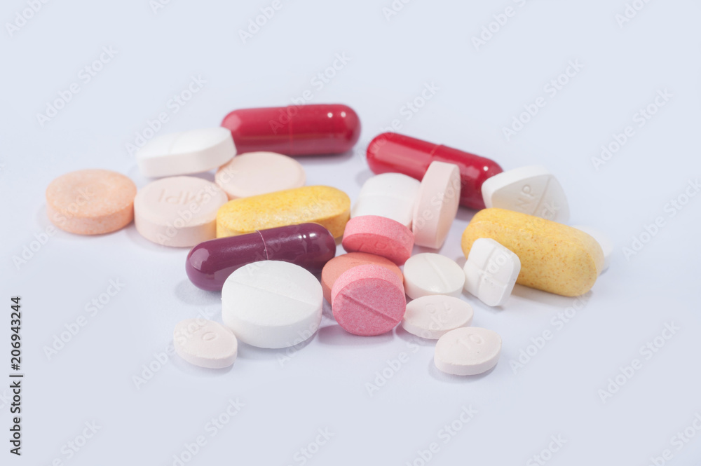 Medical pills and supplement capsule with a notebook.Medical health concept.. Medical pills and supplement capsule with a notebook.Medical health concept..