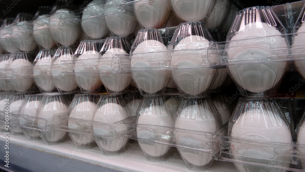 Eggs in transparent containers on the chilled shelf at grocery store Eggs in transparent containers on the chilled shelf at grocery store