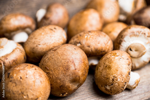 Fresh mushrooms on the rustic wooden background. Selective focus. Shallow depth of field.