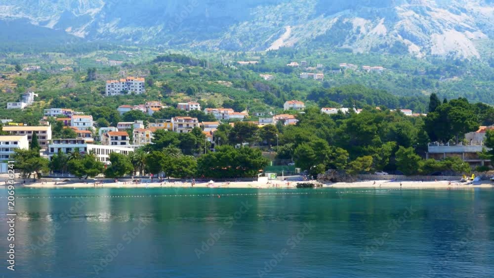 View of a beautiful Croatian beachfront town with turquoise waters View of a beautiful Croatian beachfront town with turquoise waters